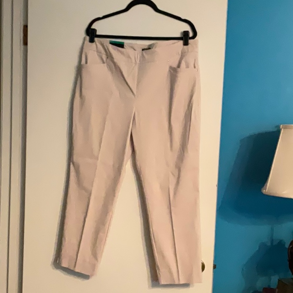 Cream colored stretch trousers.